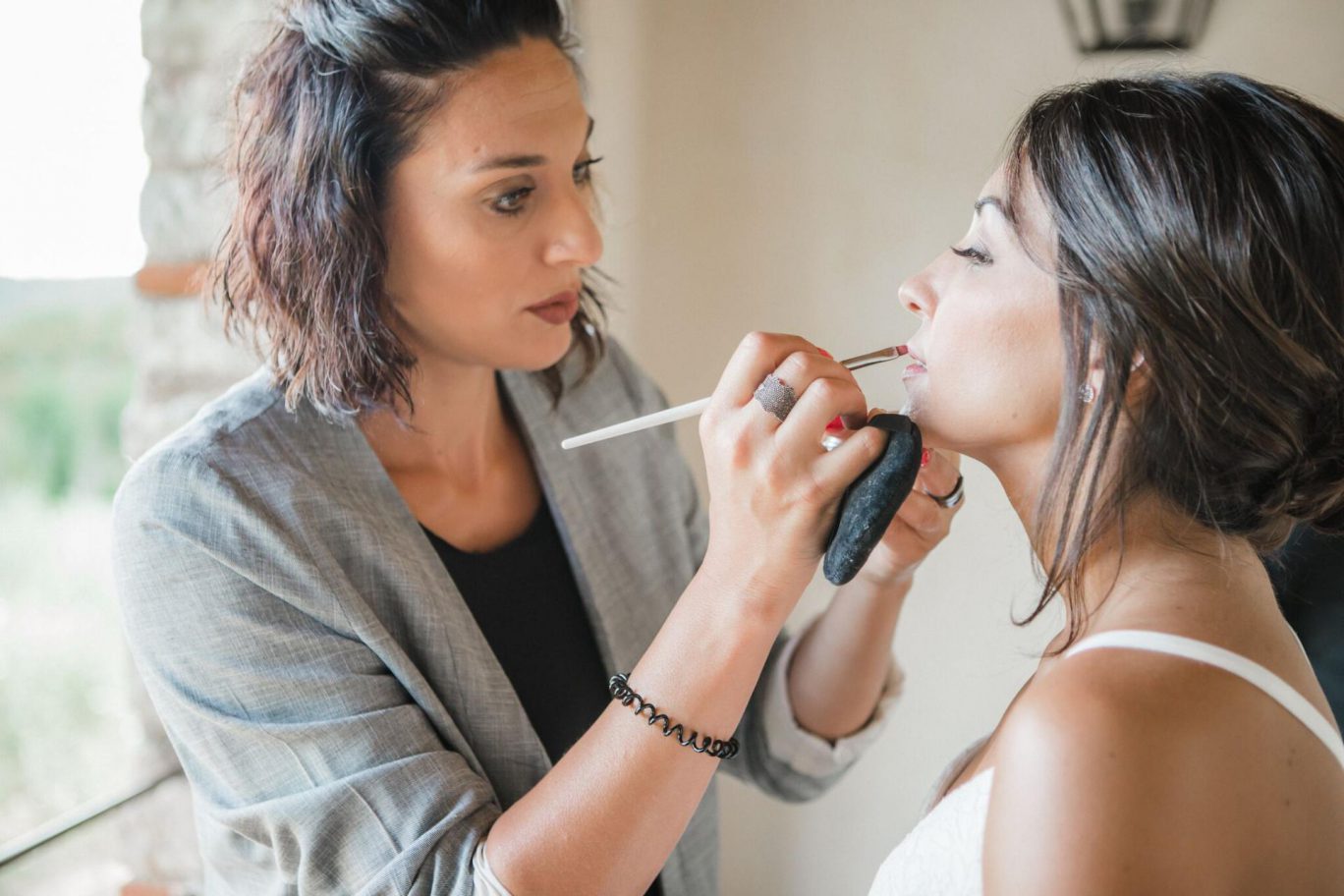 Consuelo Cardella, make up artist working on a bride